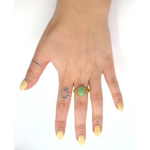 30 - An attractive cabochon jade stone ring set in silver gilt. Ring size - R. Weight - 4.52 grams.