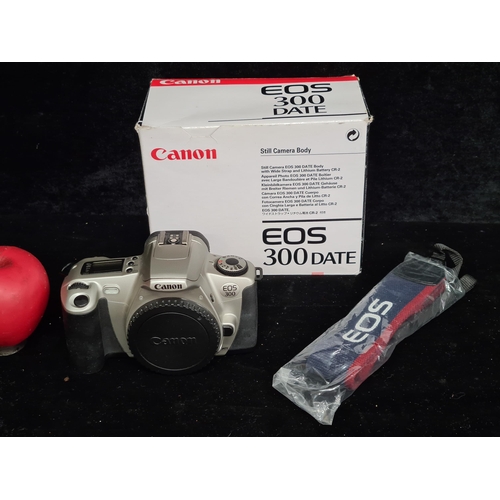 101 - A 'Canon EOS 300 SLR Date' Still Camera Body with Wide strap and Lithium Battery CR-2. In original B... 