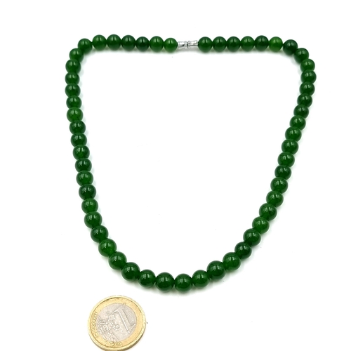 13 - A nice example of a green jade necklace set with a screw clasp. Length - 40 cms. Weight - 37 grams. ... 