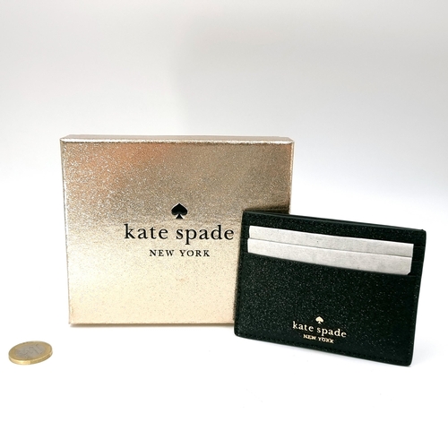 21 - An as new Kate Spade New York leather credit card wallet presented in original packaging. In gifting... 