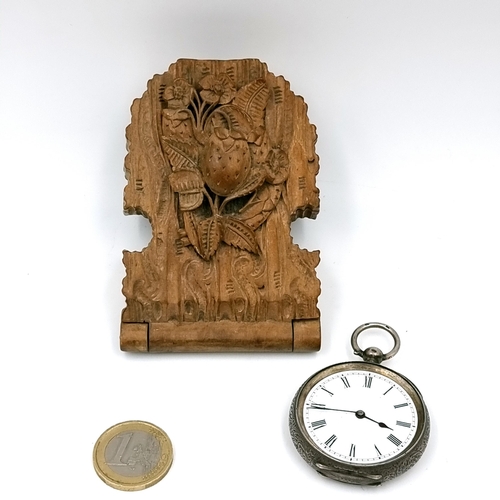 27 - An attractively carved floral design clock/watch holder containing a sterling silver pocket watch wi... 