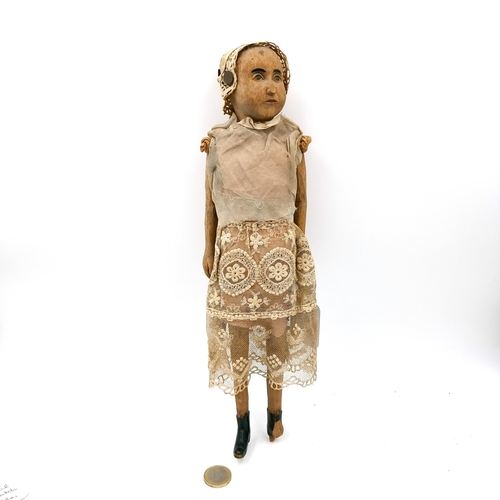 38 - An unusual antique  folk art wooden doll possibly of French origin. One foot at fault. Length - 33 c... 