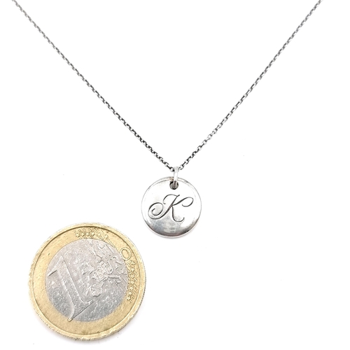 A sterling silver pendant & chain both marked Tiffany & Co. Pendant marked initial 'K'. Length of chain - 46 cms. Total weight - 3.20 grans. Comes in Tiffany & Co. pouch.