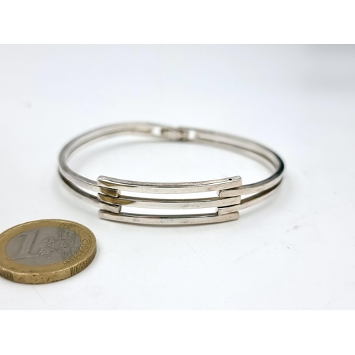 53 - A nice example of a sterling silver bangle. Weight - 16.84 grams. Presented in original box.