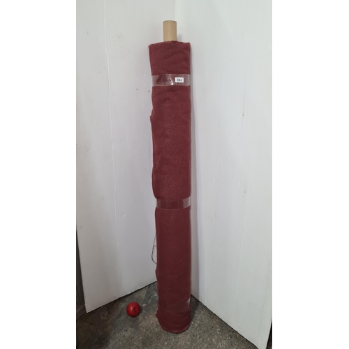 844 - A roll of burgundy fabric for furniture reupholstery.