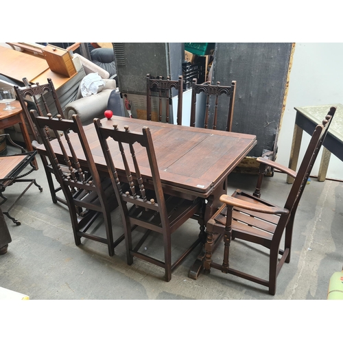 873 - Star lot : A solid well made early 20th Century ercol dining table along with six matching dinning c... 