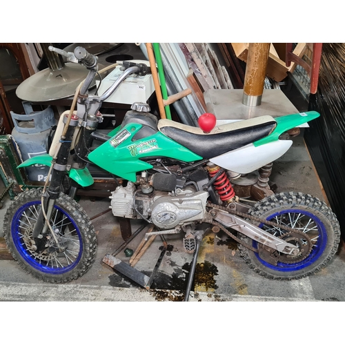 894 - Star Lot: Kawasaki dirt bike with green body and Monster Energy branding. Engine close-up detailing ... 