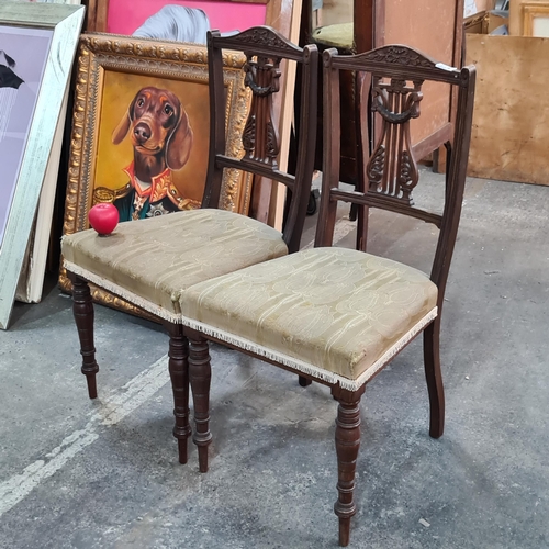 914 - Two Victorian oak dining chairs with upholstered seats and intricately carved backs.