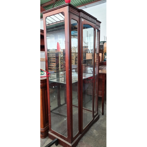 945 - A very handsome tall display cabinet with glass panels, a light fixture to top and two glass shelves... 