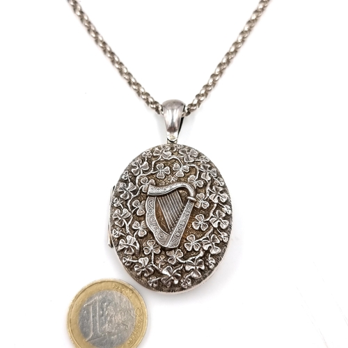 981 - An unusual vintage Sterling Silver locket with Harp and Shamrock motifs in relief. With a sterling S... 