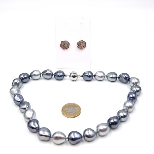 985 - A two toned Silver natrular  pearl necklace with magnetic clasp. Together with a pair of 925 Sterlin... 