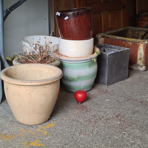 908 - A great lot of eight garden plant pots including some nice terracotta, glazed and stone examples.