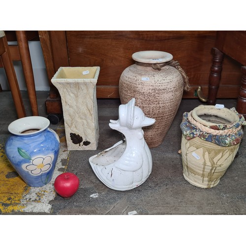 853 - A nice assortment of flower pots and vases of various shapes and sizes. Three urn styles, one being ... 