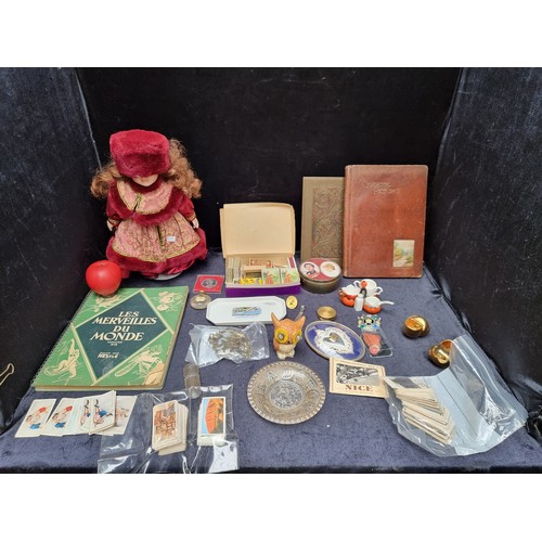 967 - An eclectic mixed of vintage items including a doll and a selection of cigarette cards.