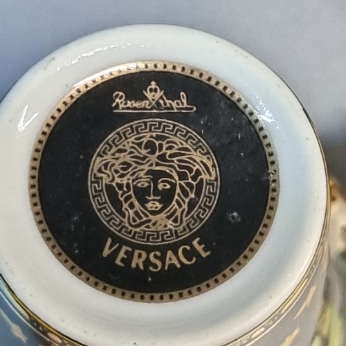 149 - Star Lot : A fabulous pair of ornate porcelain demitasse cups and saucers in the Versace design by R... 