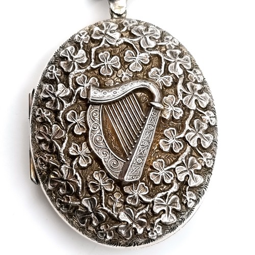 981 - An unusual vintage Sterling Silver locket with Harp and Shamrock motifs in relief. With a sterling S... 