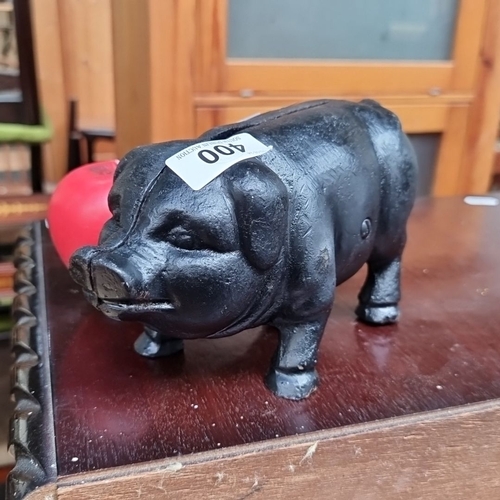 400 - A heavy Cast iron piggy bank with a black finish.