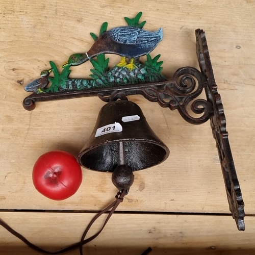 401 - A cast iron wall-mounted bell with a painted duck and duckling motif. The bell includes an intricate... 