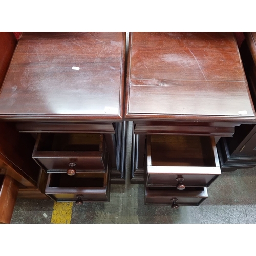 447 - Star Lot : A Pair of solid mahogany bedside tables / cabinets with two drawers and hidden drawer to ... 