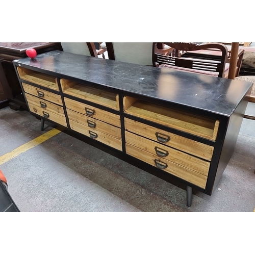 449 - Star Lot : Industrial-style low sideboard with eight drawers and two open compartments. Black metal ... 