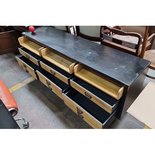 449 - Star Lot : Industrial-style low sideboard with eight drawers and two open compartments. Black metal ... 