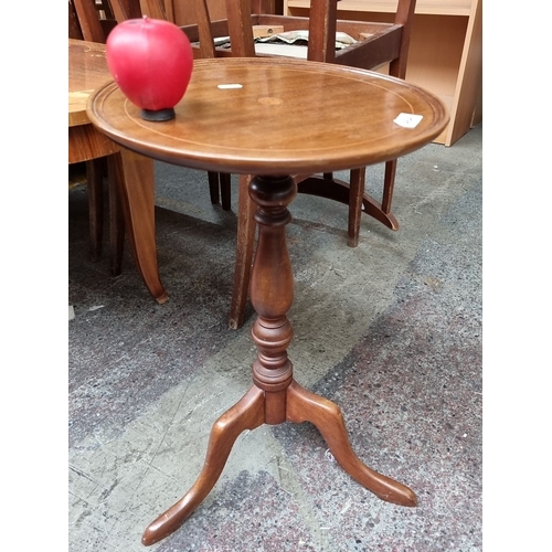 464 - A very sweet pedestal wine table with tripod base. The table features a subtle inlay design on the t... 