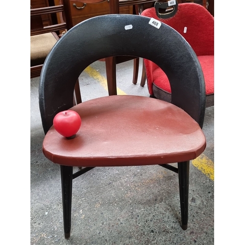 468 - Star Lot : A Mid-Century Modern chair after Antonin Suman featuring a black backrest, red seat, and ... 