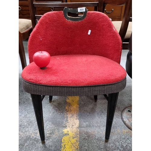 469 - An unusual  Mid-century modern red upholstered chair with black tapered legs and handle detailing.