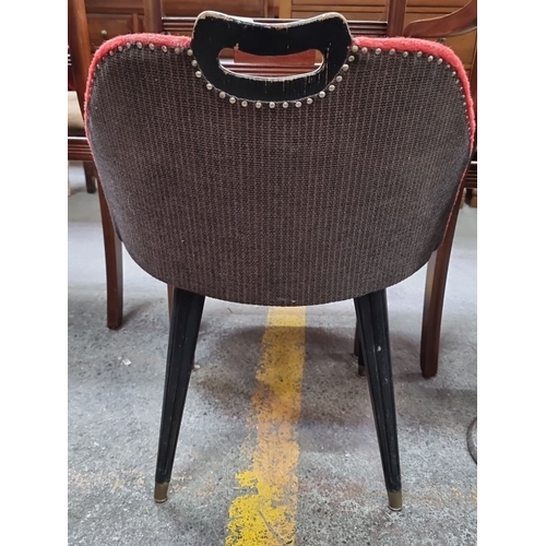 469 - An unusual  Mid-century modern red upholstered chair with black tapered legs and handle detailing.