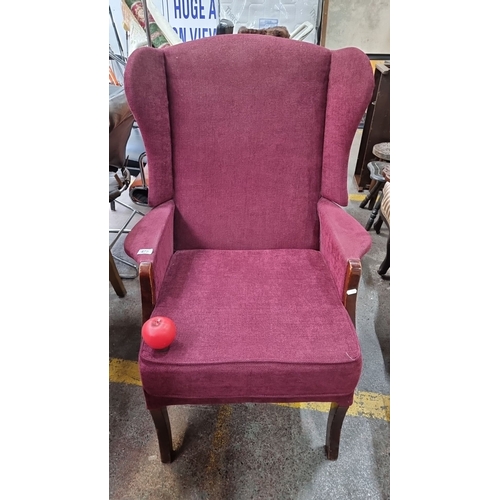 475 - Star Lot : A Vintage lovey plum coloured wingback armchair with upholstered fabric and wooden legs. ... 