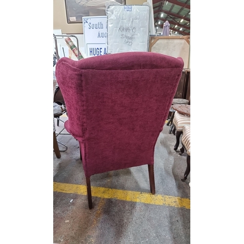 475 - Star Lot : A Vintage lovey plum coloured wingback armchair with upholstered fabric and wooden legs. ... 