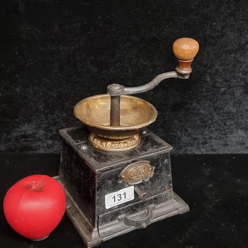 131 - An antique T&C Clarke Coffee Grinder in cast iron and with a copper bowl. A very nice example.