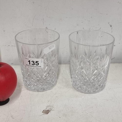 135 - A pair of large Waterford Crystal whiskey tumbler glasses. Both in good condition with acid marks to... 