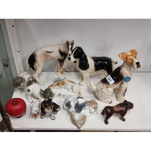 141 - A collection of 11 ceramic dog figures of different breeds, including a Lladro example.