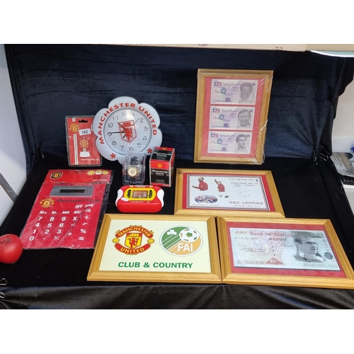 162 - An impressive collection of Manchester United memorabilia including a wall clock, a wristwatch and U... 