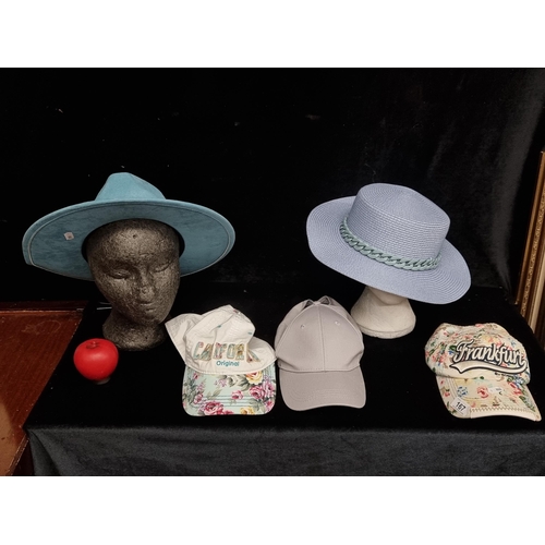 167 - A selection of five ladies hats including three baseball caps.