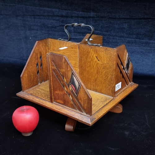 170 - A gorgeous antique oak rotary book stand of square form with four sections and hoop carrying handle ... 