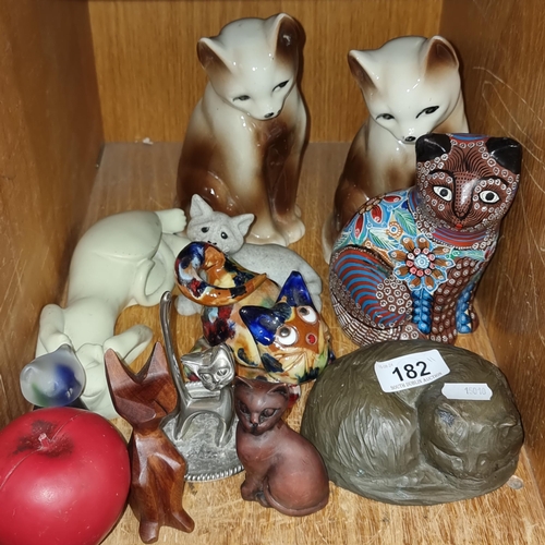 182 - A fantastic selection of eleven cat figurines including glass, wooden and ceramic examples.