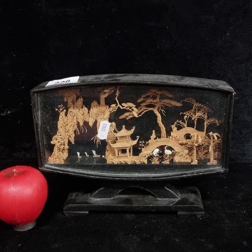 226 - An Japanese cork carving featuring traditional scenes housed in a lacquered and glass case.