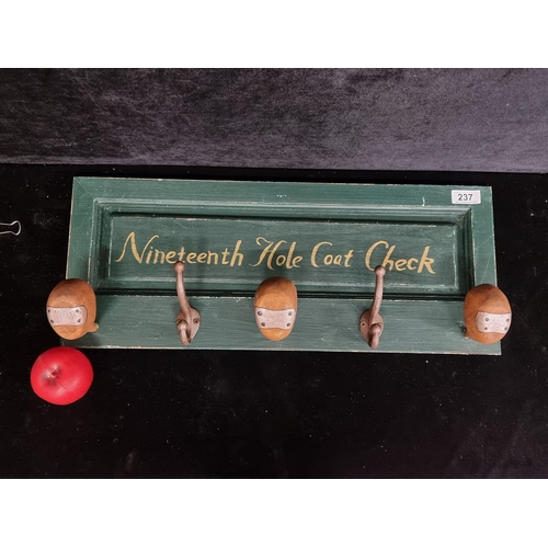 237 - A fun Golf themed  coat rack with four hooks, two of which depict the head of an antique wooden golf... 