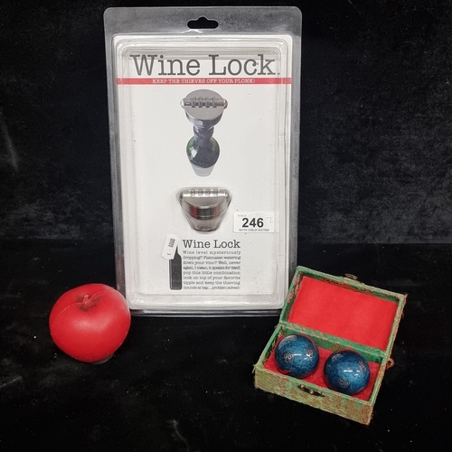 246 - Two items including a brand new sealed wine lock and a pair of cased Chinese meditation balls.