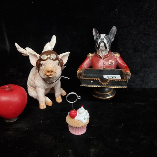 250 - Three whimsical items including a cupcake placename holder, a flying pig and a dog butler with tray.... 