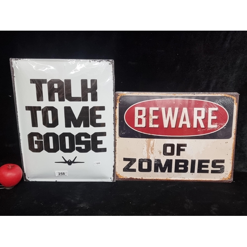 258 - Two large metal wall signs, one from the movie Top Gun and Beware of Zombies.