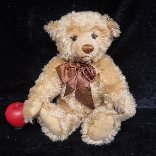 275 - A large blonde Steiff growler teddy bear. With signature button to ear and brown box.