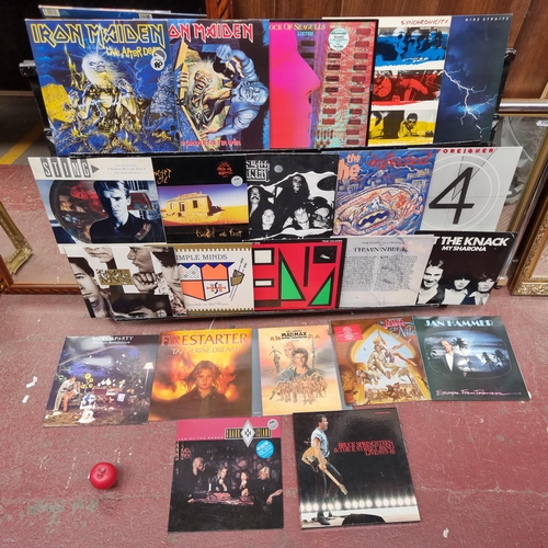 338 - A collection of approx. 22 vinyl records from artists such as Iron Maiden x 2, The Police, Dire Stra... 