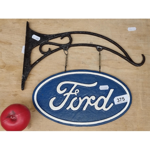 375 - A heavy cast metal double sided Ford Motors wall mounted advertising sign.