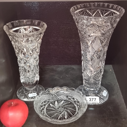 377 - A selection of three Crystal cut glass items including a pair a two vases and a bowl. Slight chip to... 