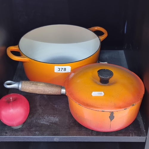 378 - Two Le Creuset dishes including one handled oven dish and one saucepan with spout and wooden handle.... 