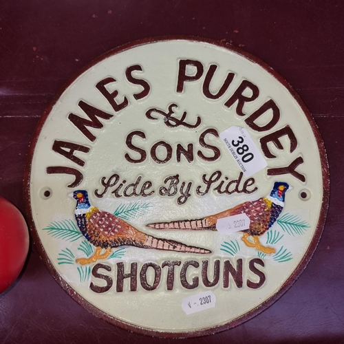 380 - A circular cast metal advertising sign for ''James Purdey & Sons Side By Side Shotguns'' Featuring a... 