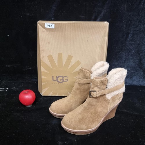 234 - A pair of Ugg Australia wedge boots in suede and sheepskin. Brand new in original box. Marked size u... 